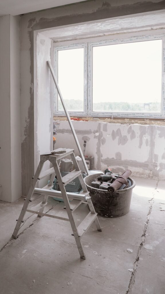 Sunlit room under renovation with tools and ladder, embodying modern DIY projects